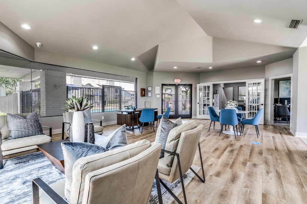 a living room with couches and chairs and a dining table