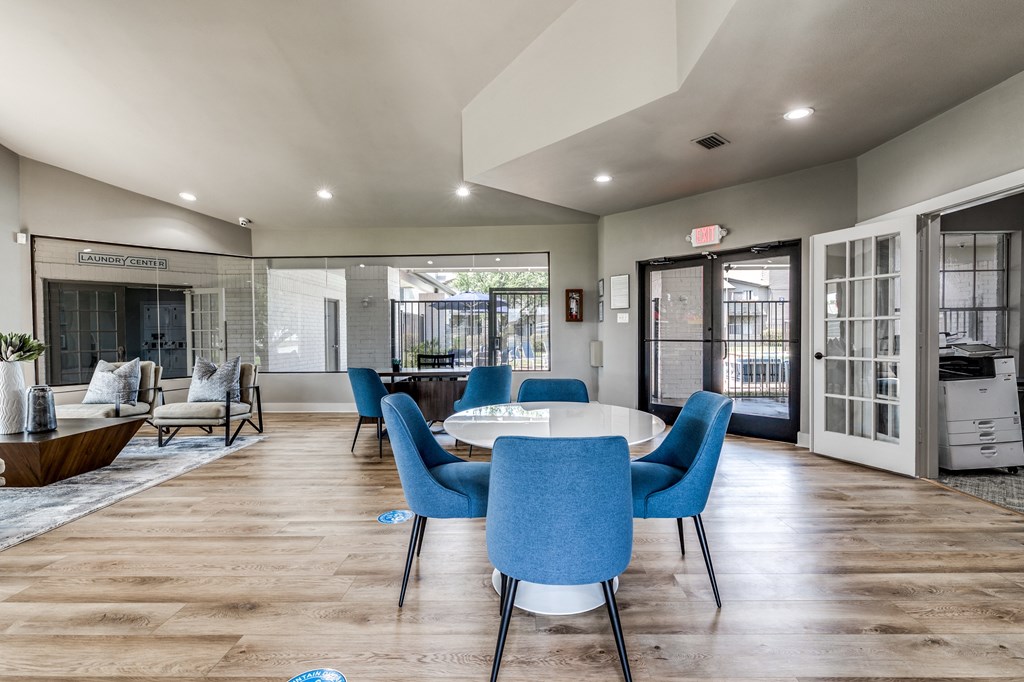 a dining room with blue chairs and a white table