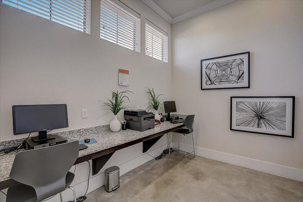 an office with a desk with a computer on it