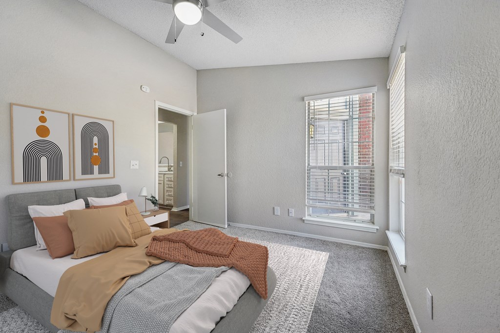 a bedroom with a bed and a ceiling fan