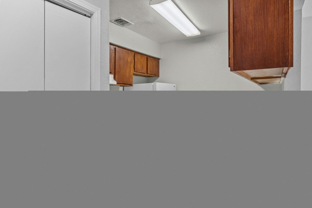 a kitchen with white appliances and a sink and a refrigerator