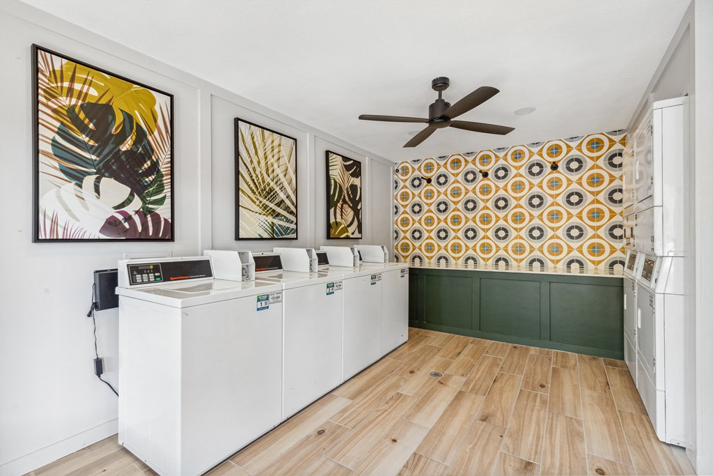 a laundry room with washers and dryers