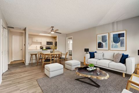 our apartments offer a living room with a couch a coffee table and a dining table