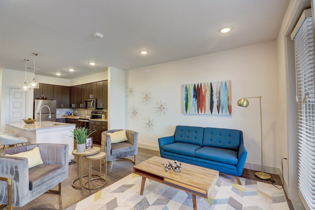a living room with a blue couch and a coffee table