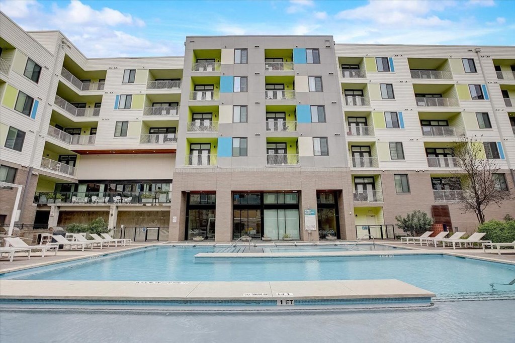 a swimming pool in front of an apartment building