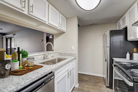 an open kitchen with granite counter tops and stainless steel appliances