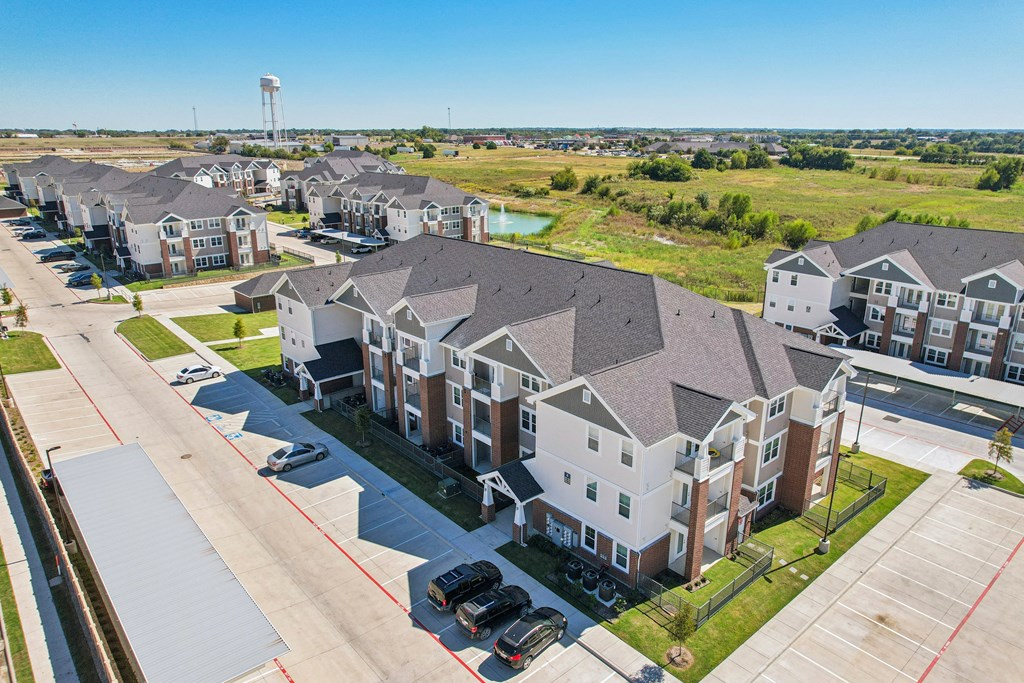 A row of houses with a water tower in the distance.