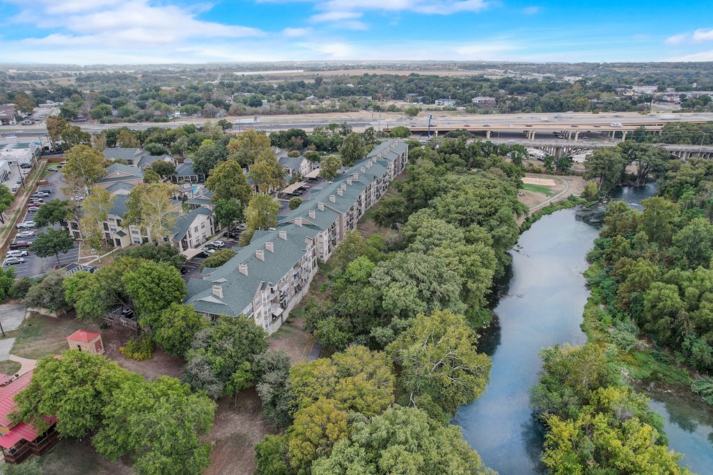 an aerial view of a row of houses next to a river