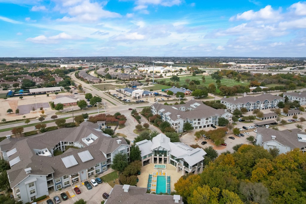 an aerial view of a neighborhood with houses and cars on the street