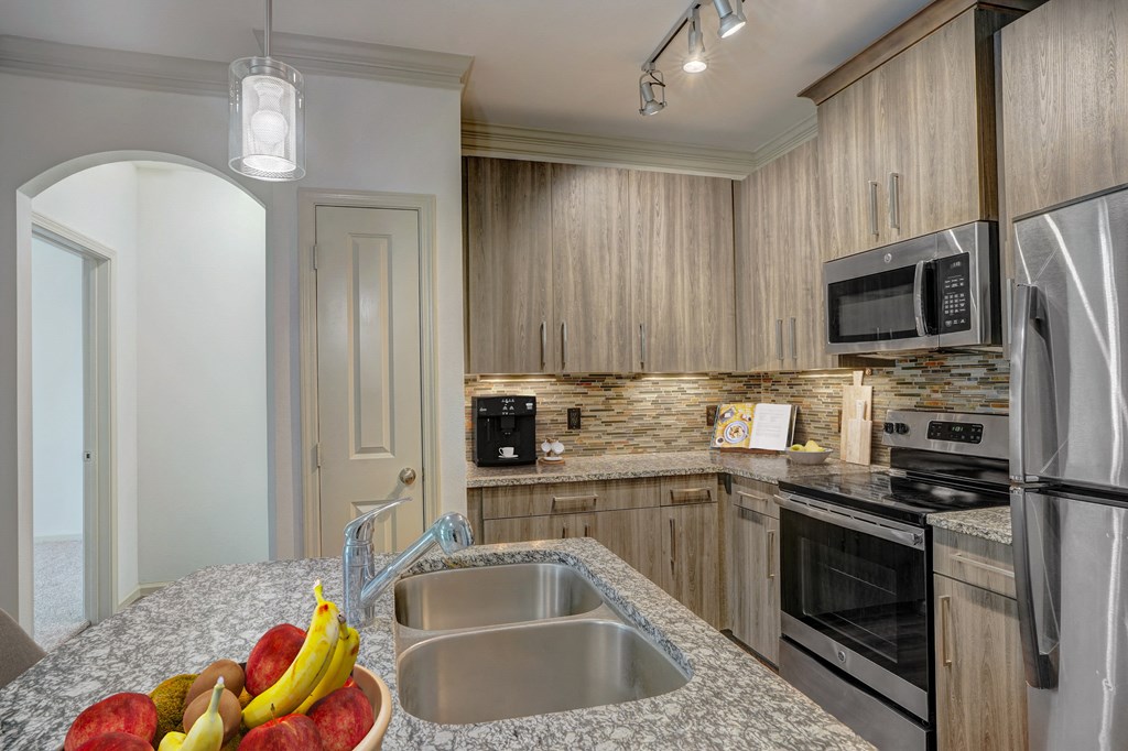 a kitchen with granite counter tops and stainless steel appliances