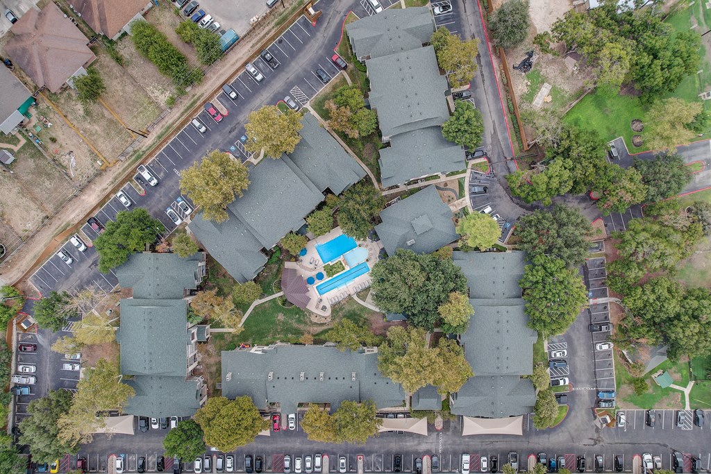 an aerial view of a neighborhood with houses and a street