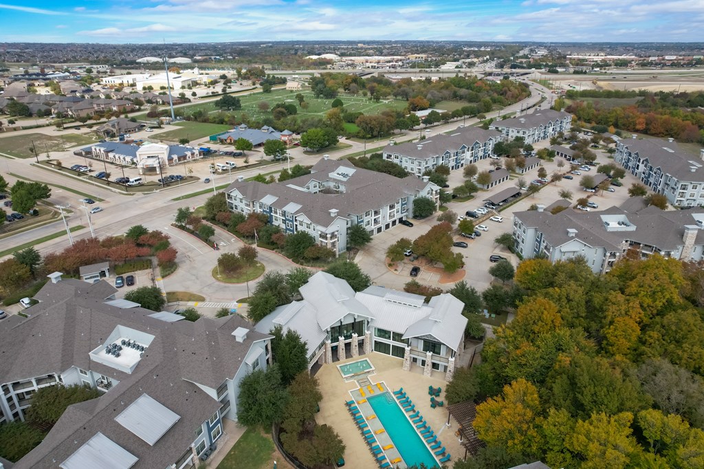 an aerial view of a neighborhood with houses and a swimming pool