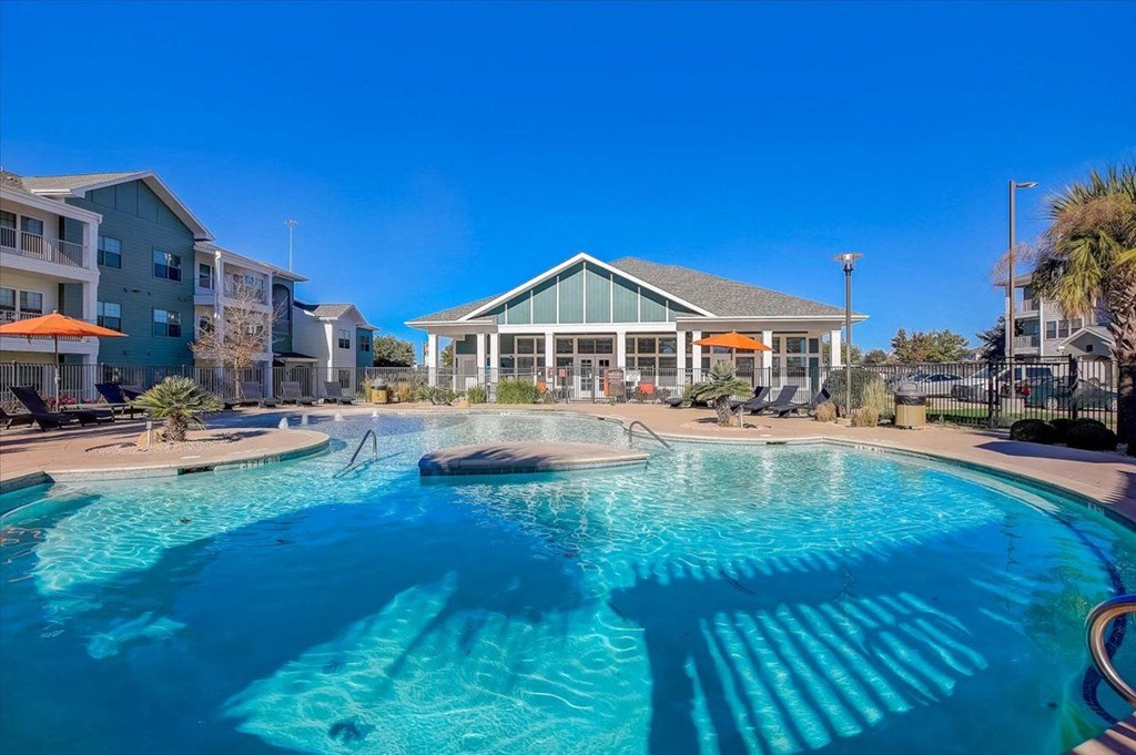 a large swimming pool with a building in the background