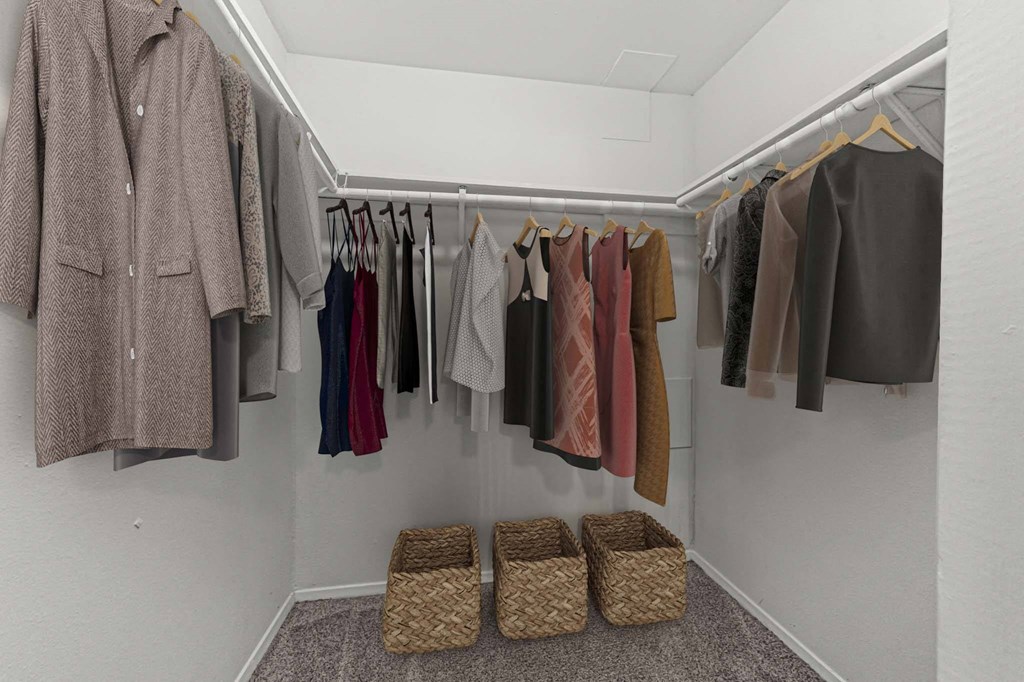 a closet with a rack of clothes and baskets
