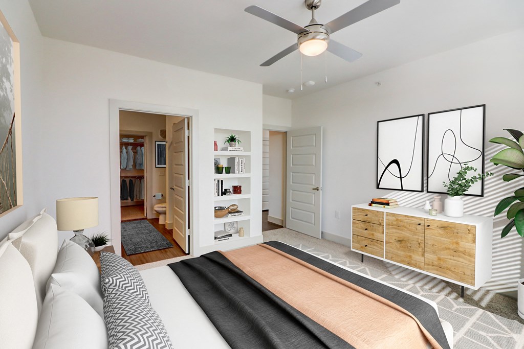 a bedroom with a bed and a ceiling fan