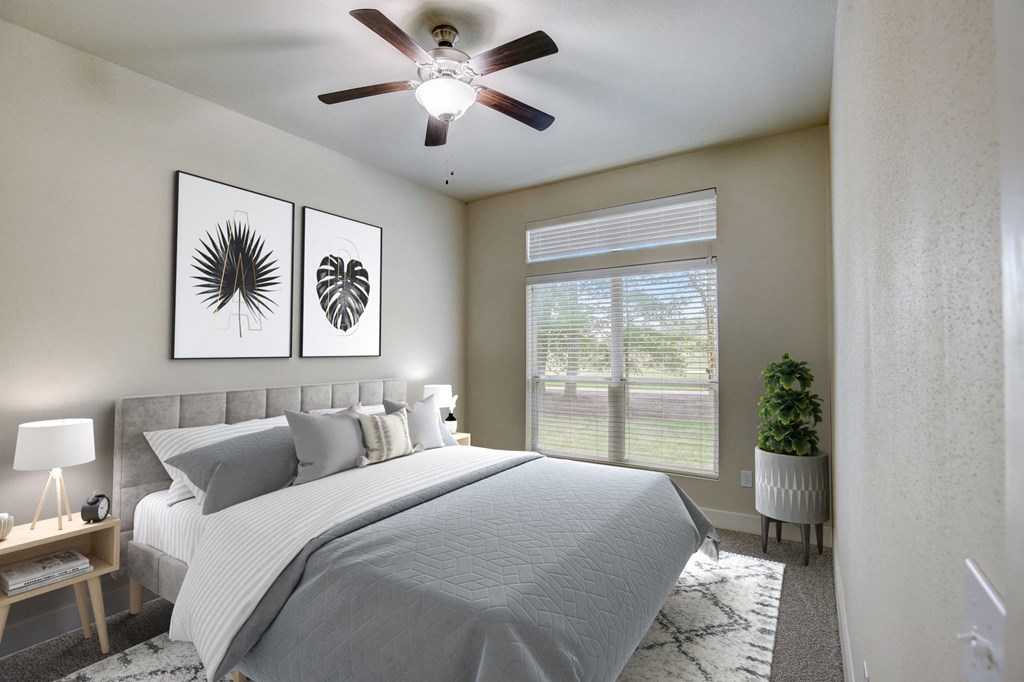 a bedroom with a large bed and a ceiling fan