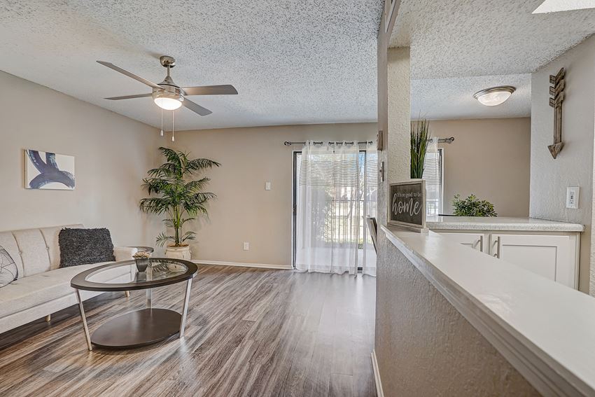 a living room with a couch and a ceiling fan