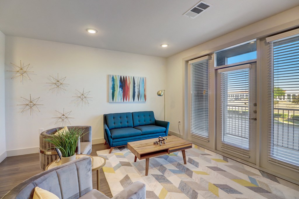 a living room with a blue couch and a coffee table