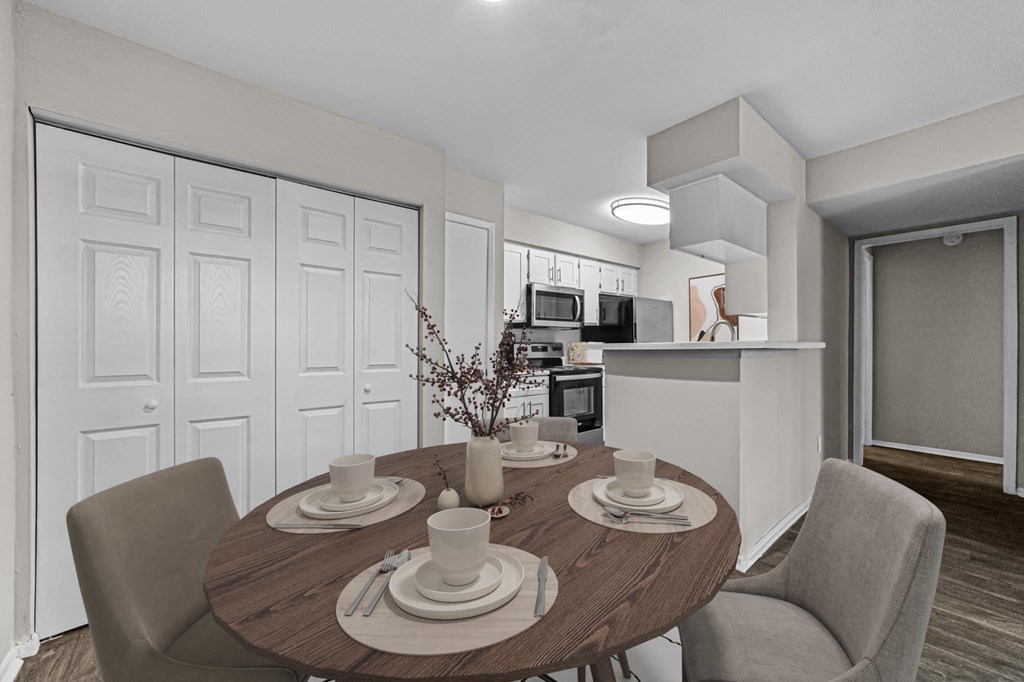 a dining room and kitchen with a table and chairs