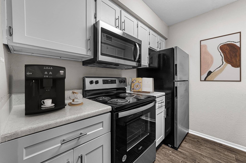 a kitchen with black appliances and white cabinets