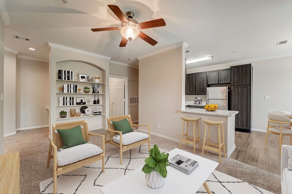 a living room and kitchen with a ceiling fan