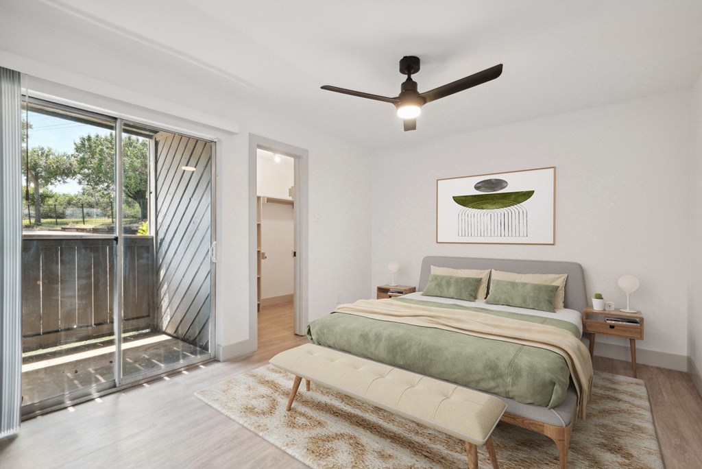 a bedroom with a bed and a ceiling fan