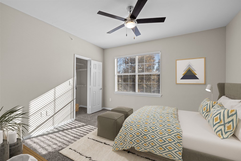 a bedroom with a large bed and a ceiling fan