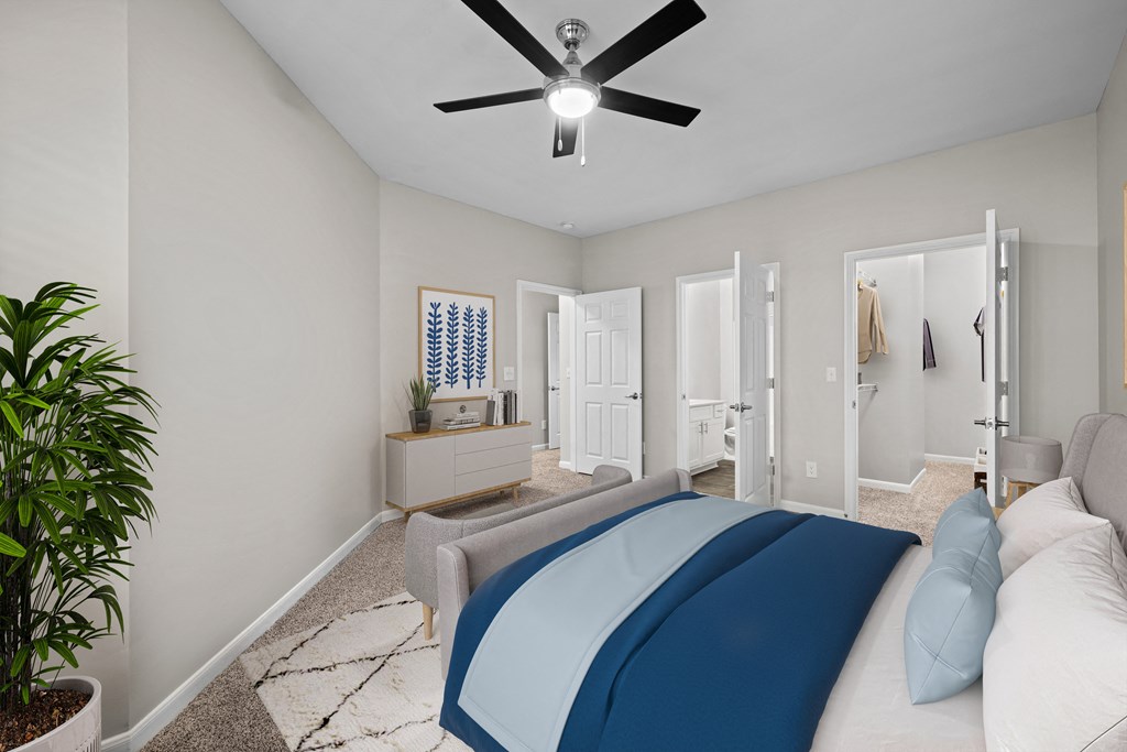 a bedroom with a large bed and a ceiling fan