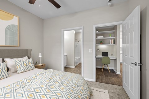 a bedroom with a large bed and a closet with a desk