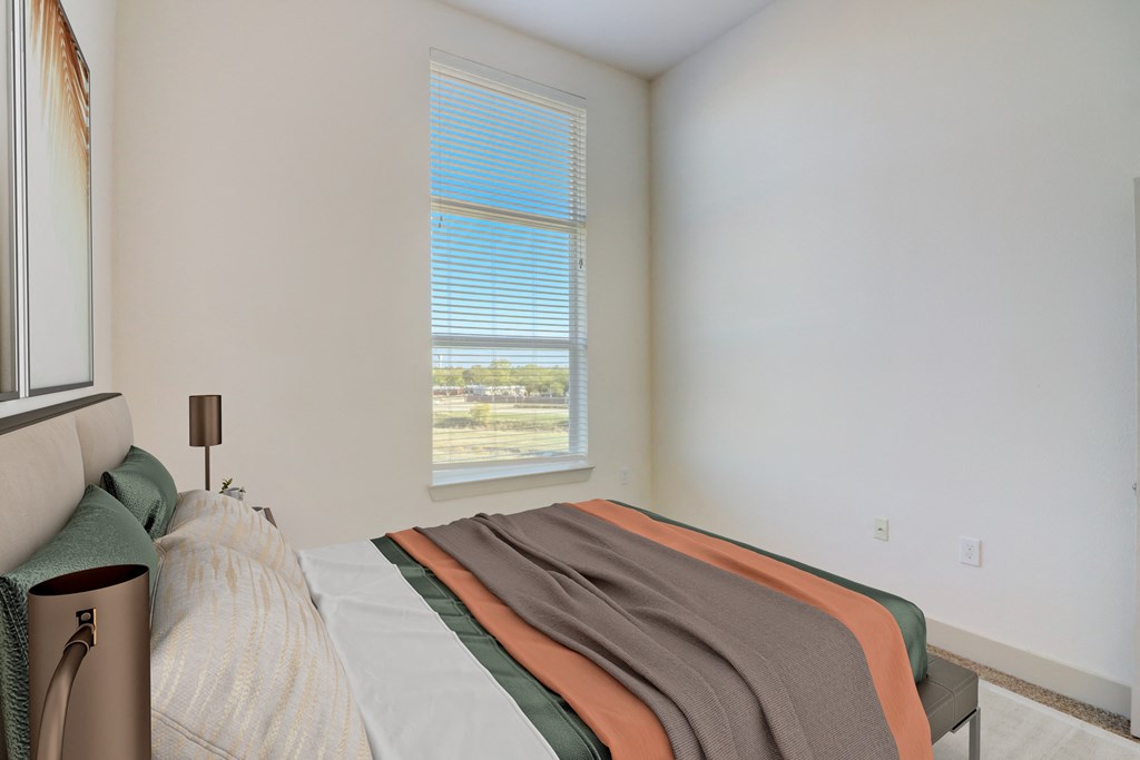 an empty bedroom with a bed and a window