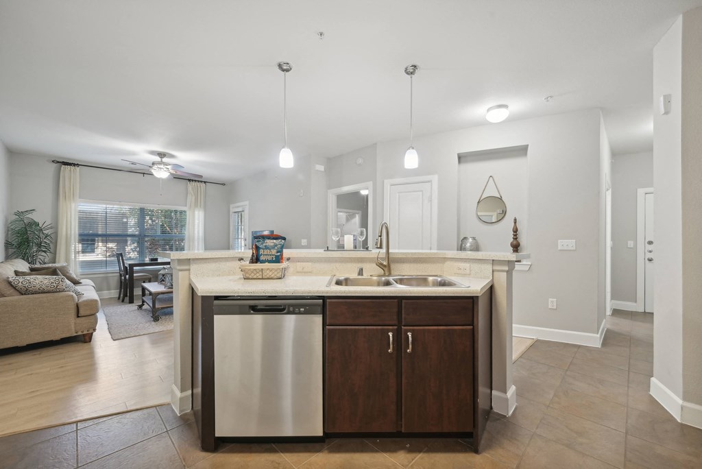A modern kitchen with a large island and stainless steel appliances.