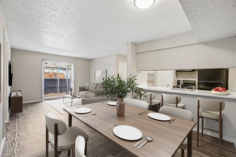 A dining room with a wooden table set for two.