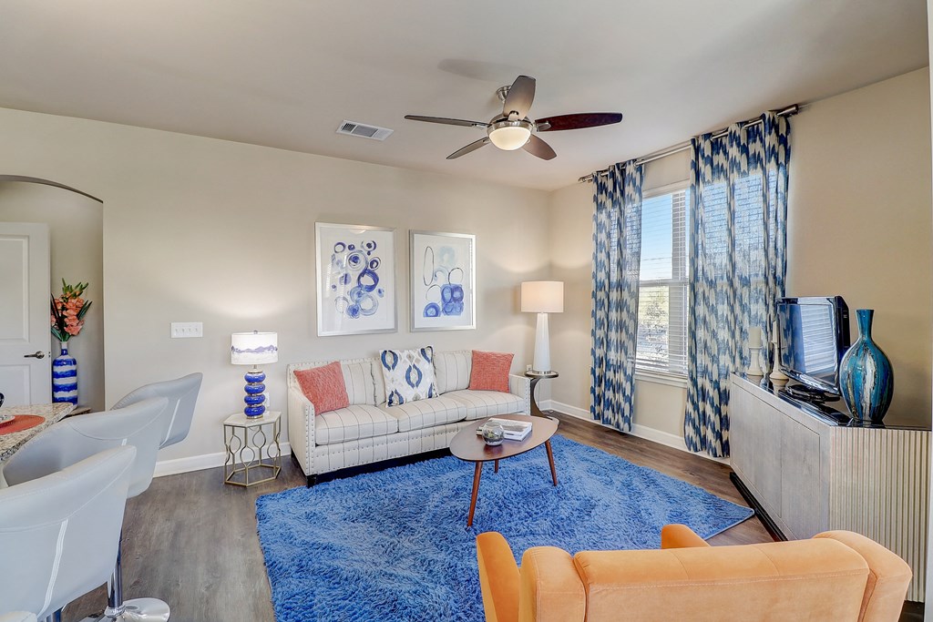 a living room with a blue rug and a couch