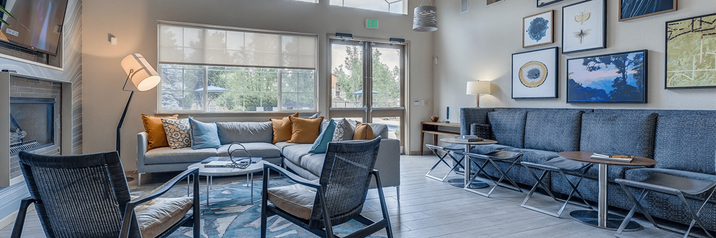 a living room with couches and chairs and a fireplace