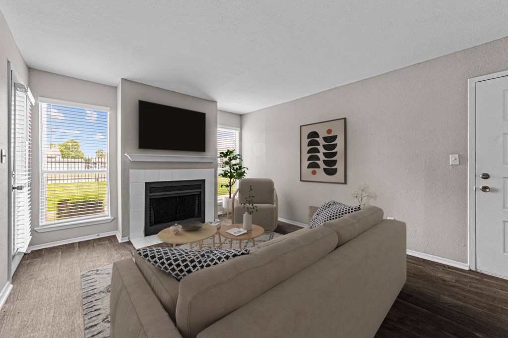 the living room of an apartment with a couch and a fireplace