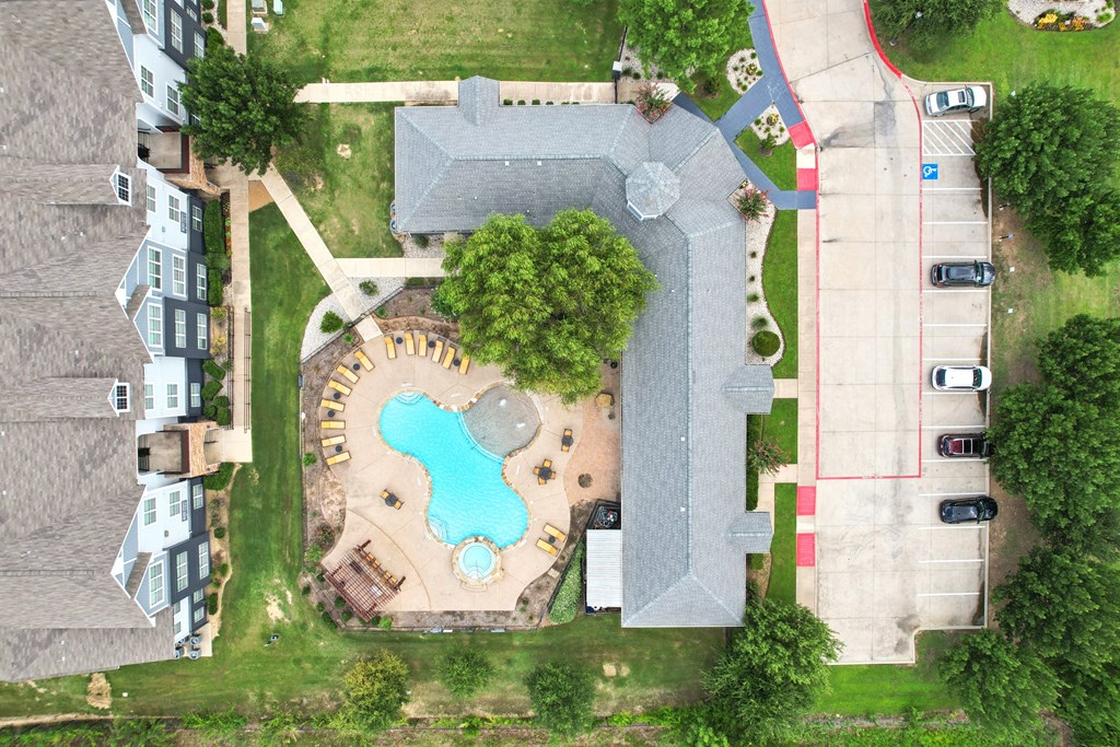 A bird's eye view of a residential area with a swimming pool and a playground.