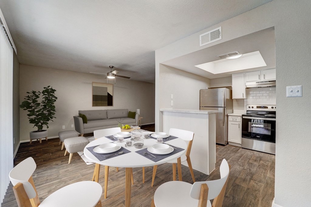 a living room and dining room with a white table and chairs