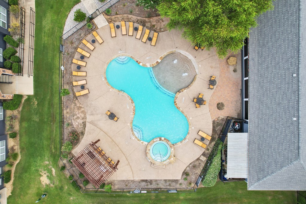 A large outdoor pool with a sign that says "MUJIN".