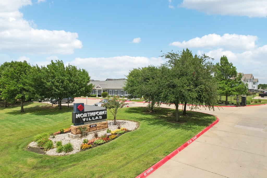A sign for Northpoint Villas is in the middle of a landscaped area.