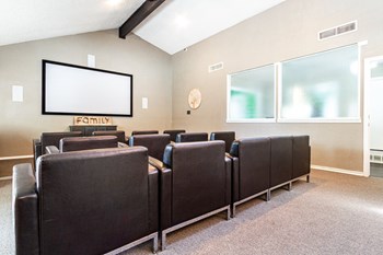 a small conference room with brown leather chairs and a white screen on the wall - Photo Gallery 14