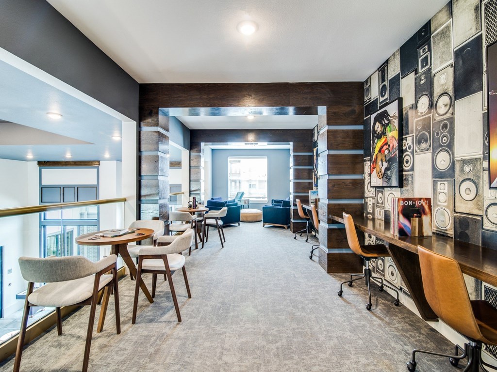 a room with tables and chairs and a large window