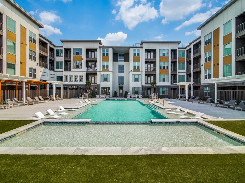 a swimming pool in front of an apartment building