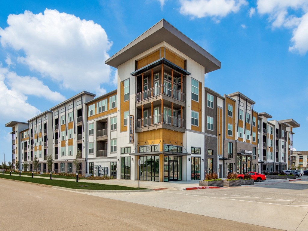 a large apartment building with a street in front of it