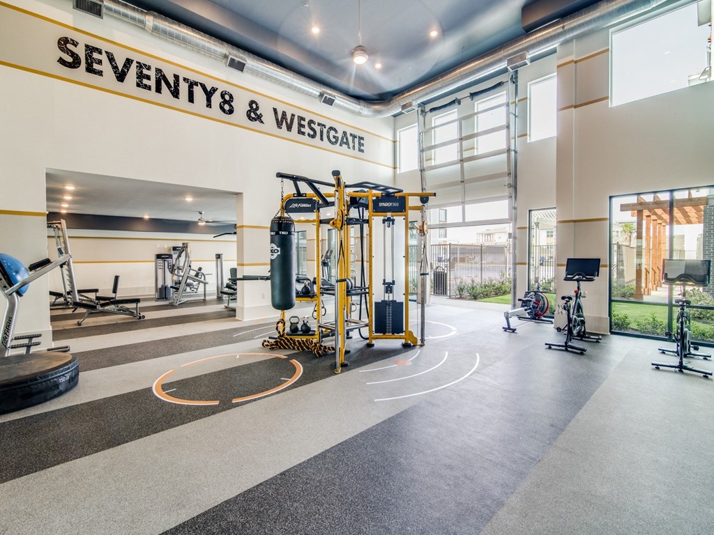 a gym with weights and cardio equipment and a sign that says seventh  wesley