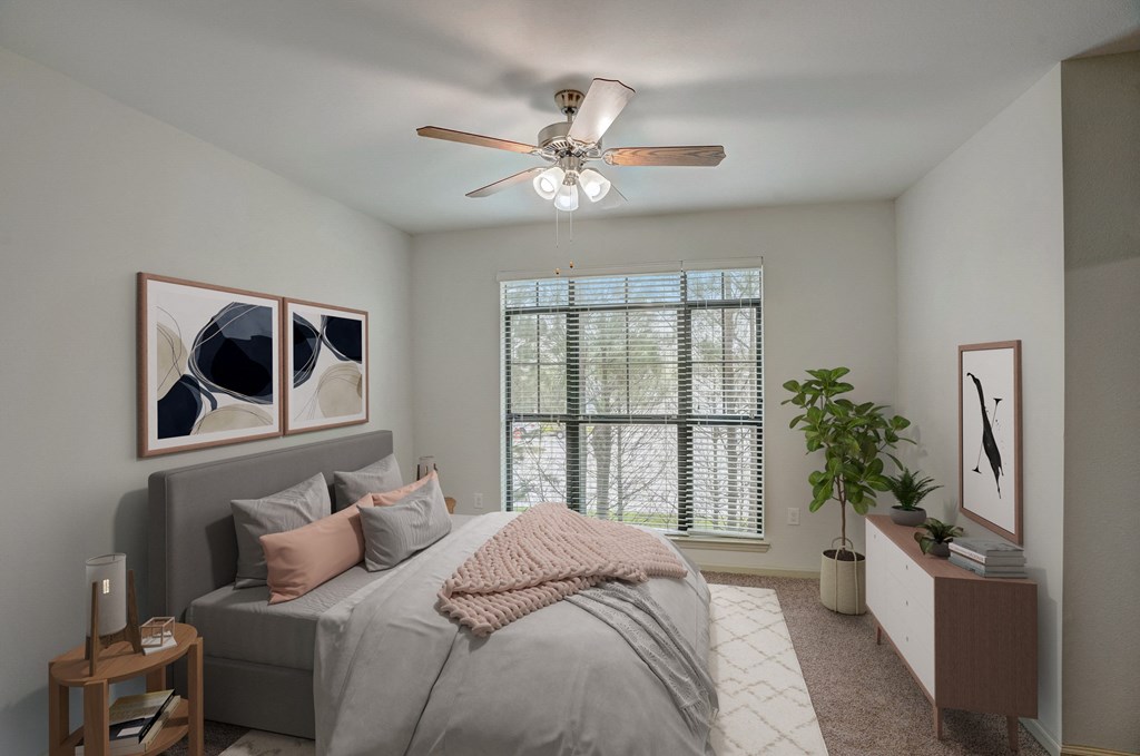 a bedroom with a large bed and a ceiling fan
