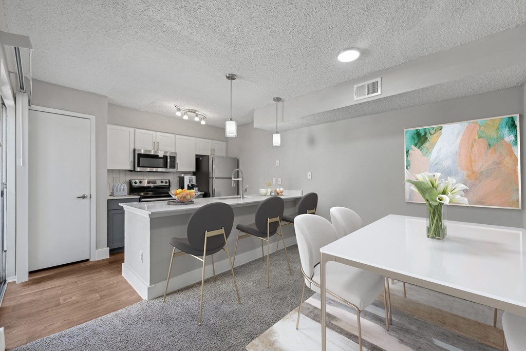 an open kitchen and dining room with a white table and chairs