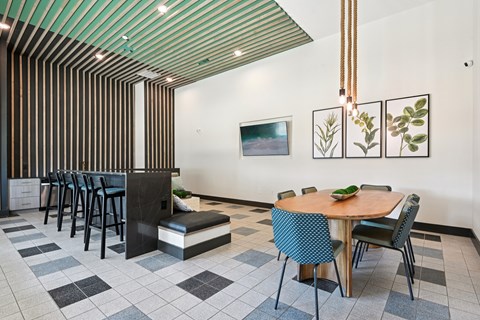 A dining room with a wooden table surrounded by chairs.