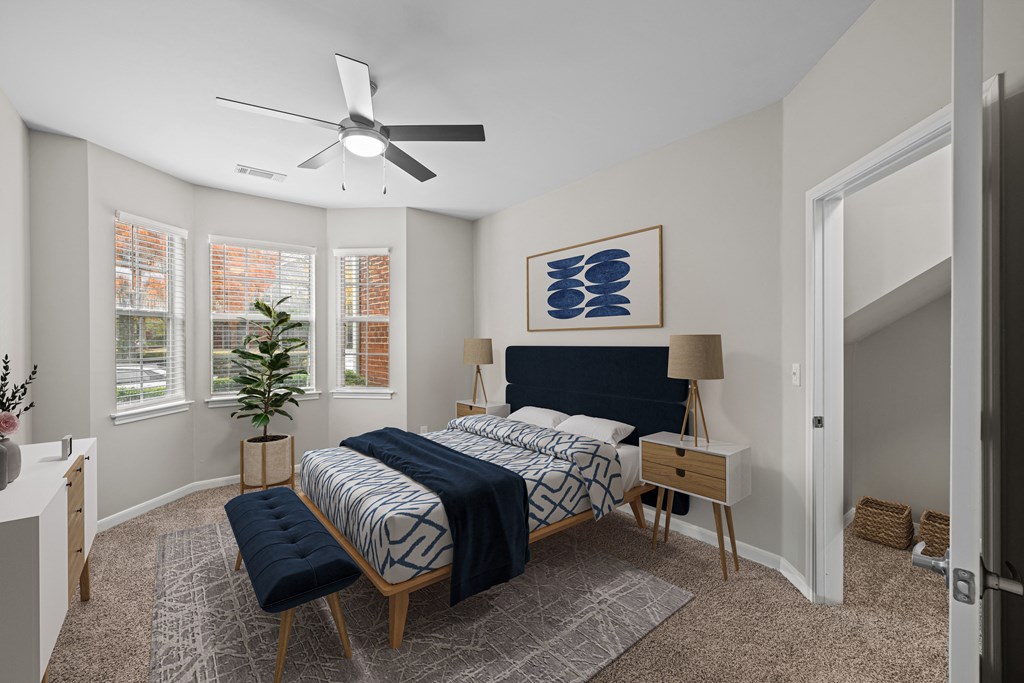 a bedroom with a large bed and a ceiling fan