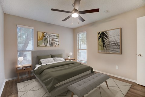 a bedroom with a bed and a ceiling fan