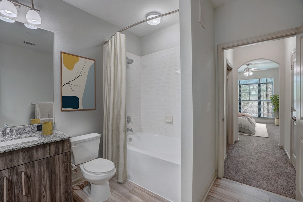 a bathroom with a shower and a toilet and a sink